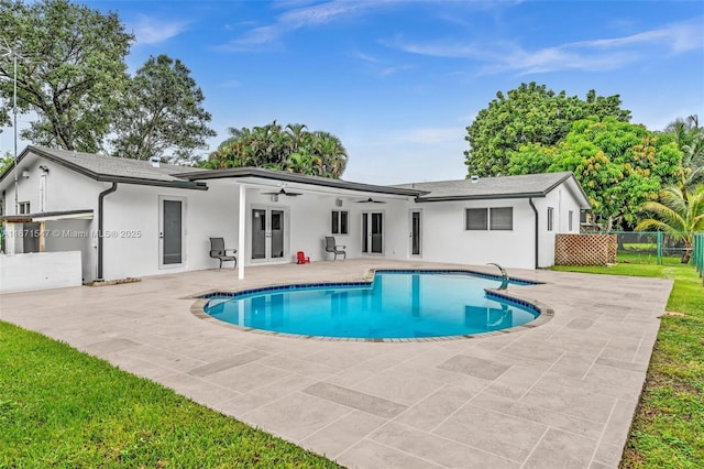 back of house featuring a fenced in pool, ceiling fan, and a patio area