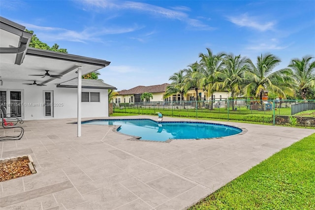 view of pool featuring ceiling fan, a patio area, and a lawn