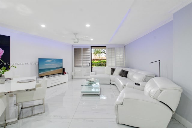 living room featuring ceiling fan and crown molding