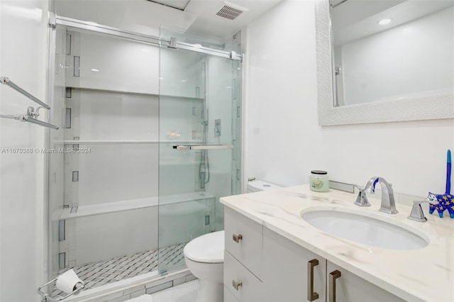 bathroom with walk in shower, vanity, and toilet