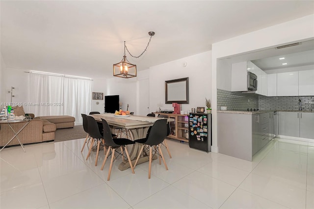 dining area with an inviting chandelier and light tile patterned floors