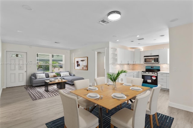 dining space with light hardwood / wood-style floors