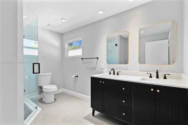 bathroom featuring vanity, toilet, and an enclosed shower