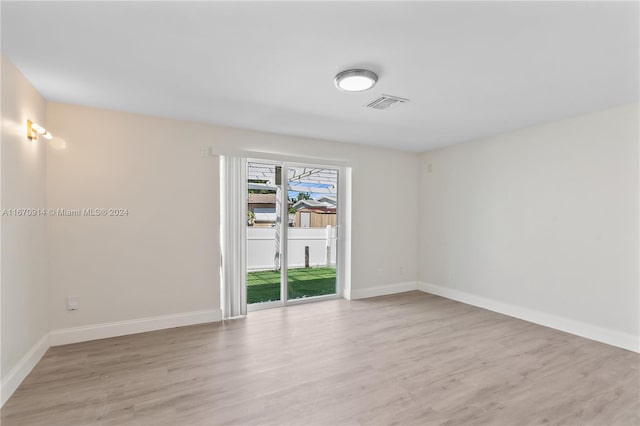 spare room featuring light hardwood / wood-style floors