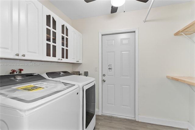 laundry room with ceiling fan, separate washer and dryer, cabinets, and light hardwood / wood-style floors