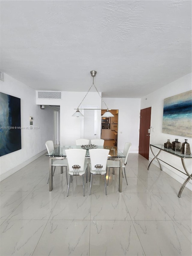 dining area featuring a textured ceiling