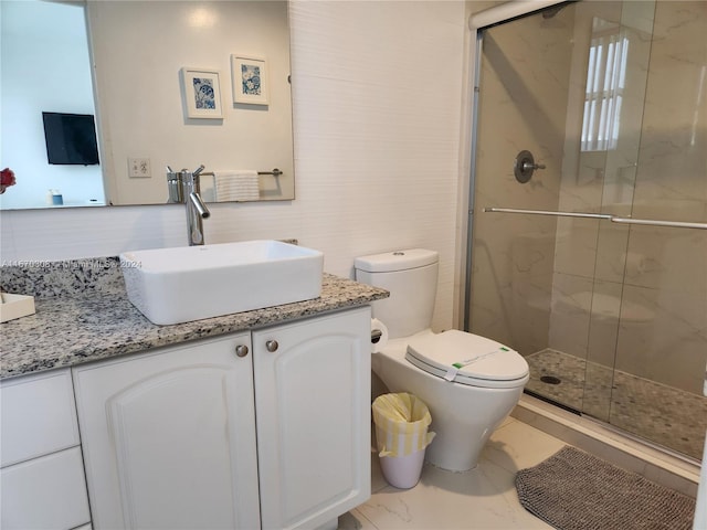 bathroom with a shower with shower door, vanity, and toilet