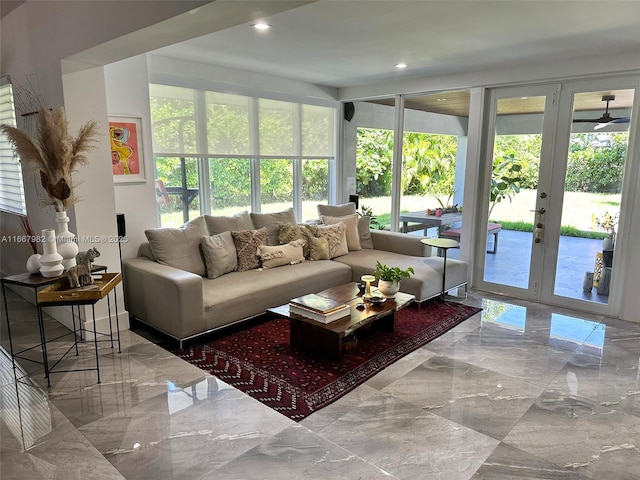 sunroom featuring ceiling fan and french doors