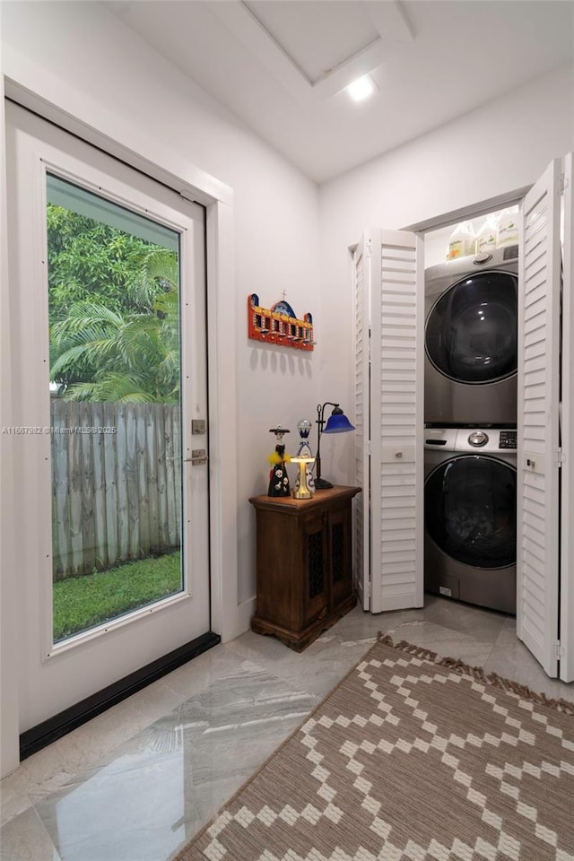 washroom featuring stacked washer and dryer