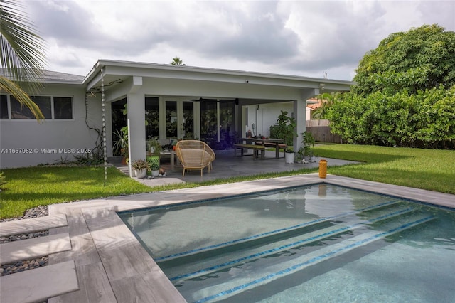 back of property featuring a patio area and a yard