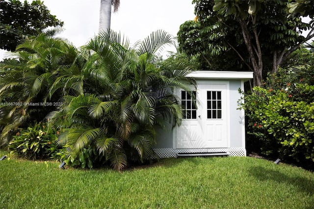 view of outbuilding featuring a yard