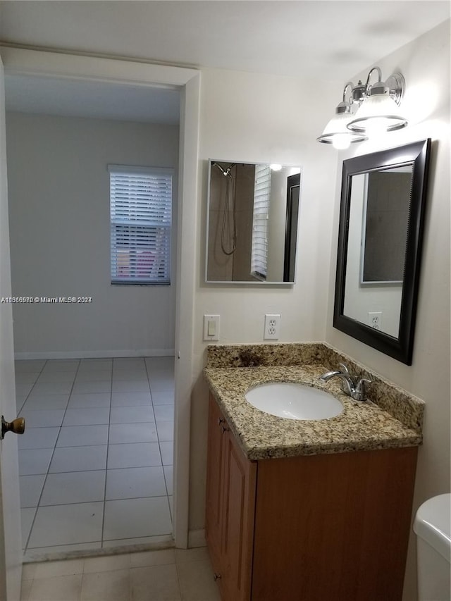 bathroom featuring tile patterned flooring, vanity, and toilet