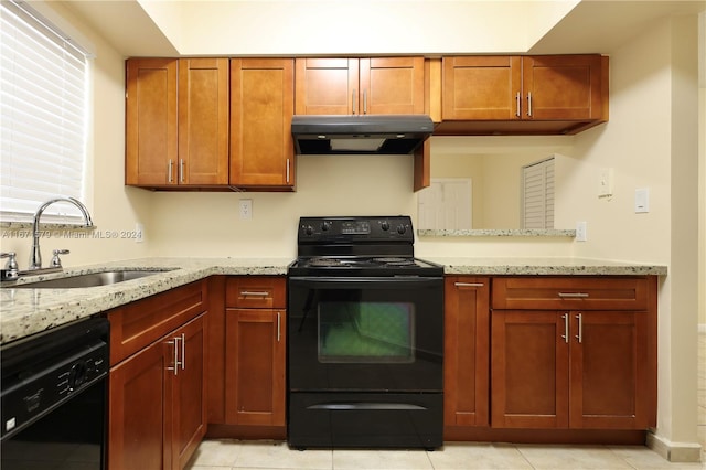 kitchen featuring black appliances, sink, light tile patterned floors, and light stone counters