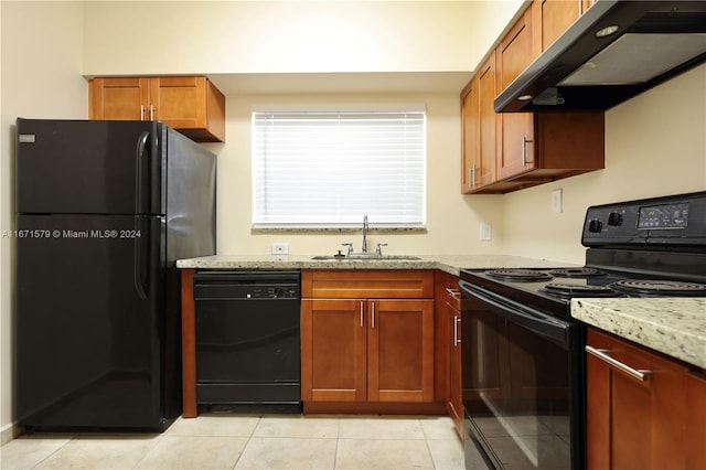 kitchen featuring light stone countertops, black appliances, sink, and extractor fan