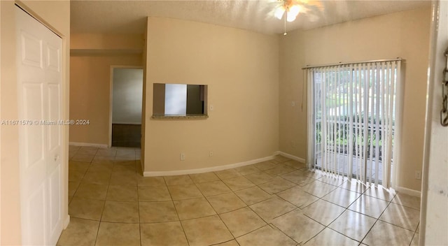 unfurnished room featuring ceiling fan and light tile patterned floors