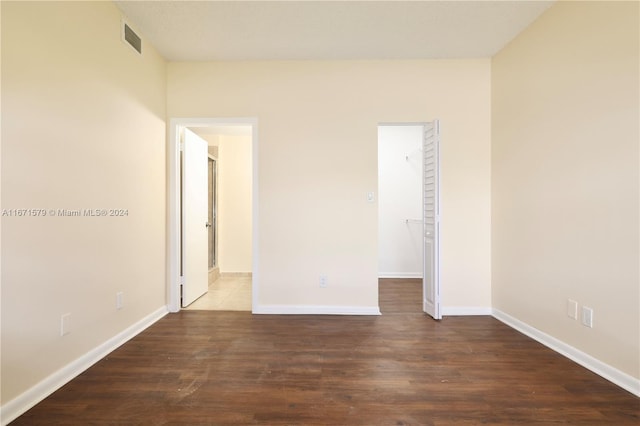 spare room featuring dark hardwood / wood-style flooring