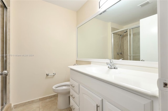 bathroom featuring vanity, tile patterned floors, an enclosed shower, and toilet