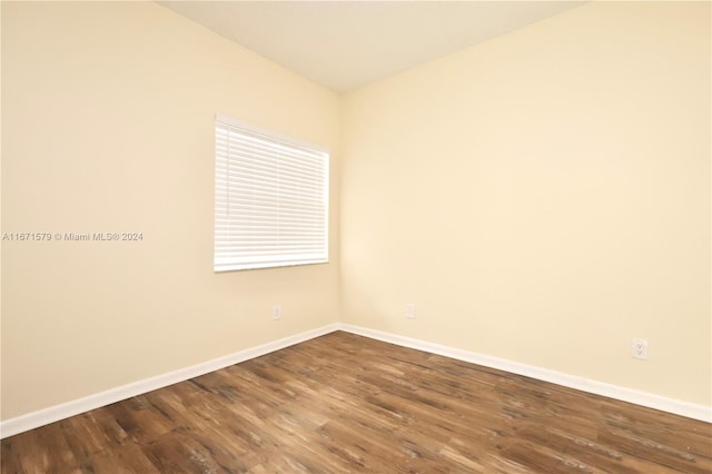 spare room featuring dark wood-type flooring