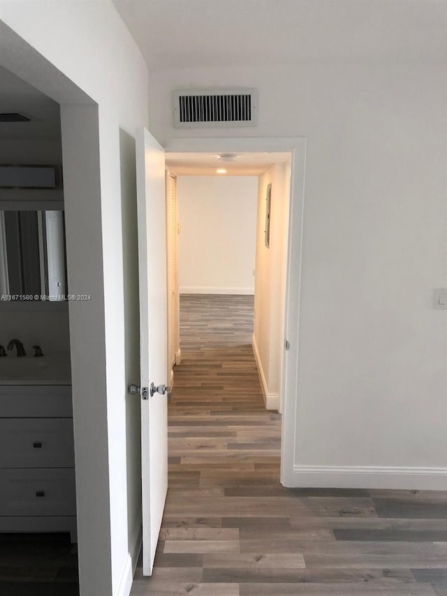 hall with dark hardwood / wood-style floors and sink