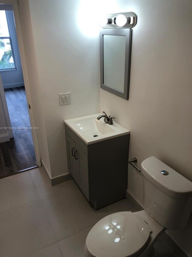 bathroom featuring tile patterned floors, vanity, and toilet