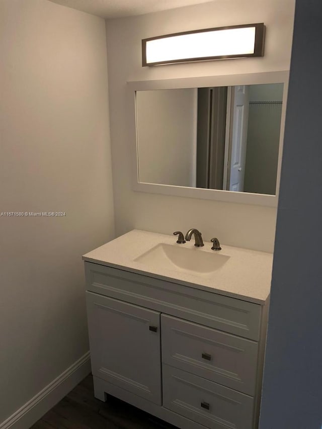 bathroom featuring wood-type flooring and vanity