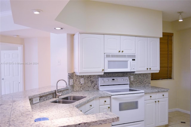 kitchen with decorative backsplash, white appliances, white cabinetry, and sink