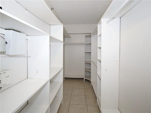 walk in closet featuring light tile patterned flooring