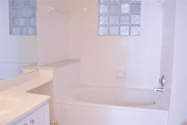 bathroom featuring vanity and tiled shower / bath