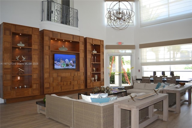 3225 NE 184th St Unit 10103, Aventura, FL 33160 - living area featuring a towering ceiling, a chandelier, and wood finished floors