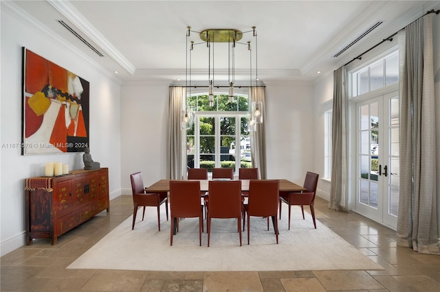 dining space with french doors and crown molding