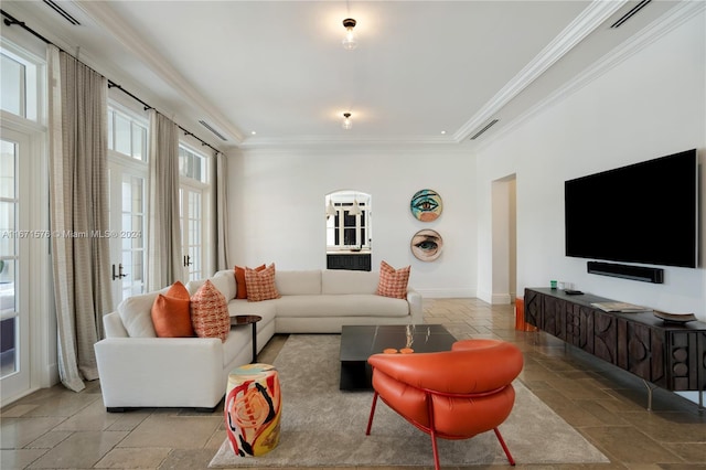 living room featuring crown molding and a healthy amount of sunlight