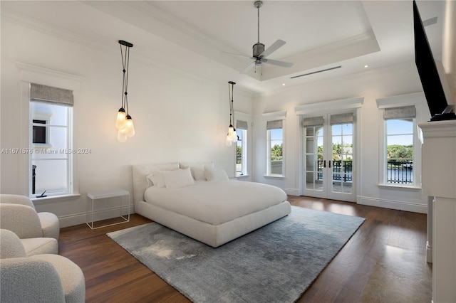 bedroom with access to outside, a raised ceiling, dark hardwood / wood-style floors, and ceiling fan