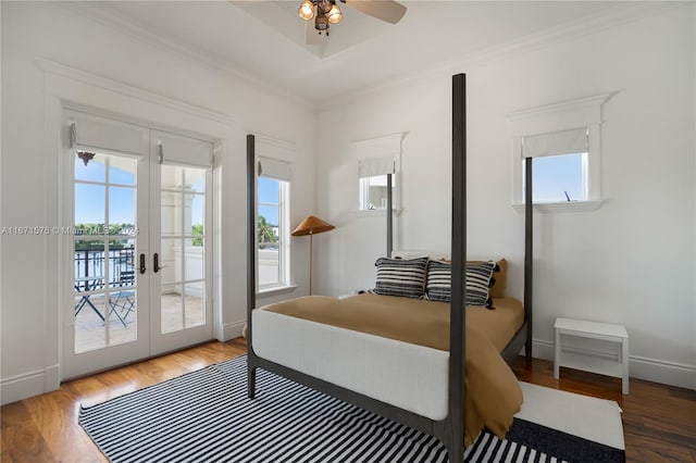 bedroom featuring multiple windows, hardwood / wood-style flooring, access to exterior, and crown molding