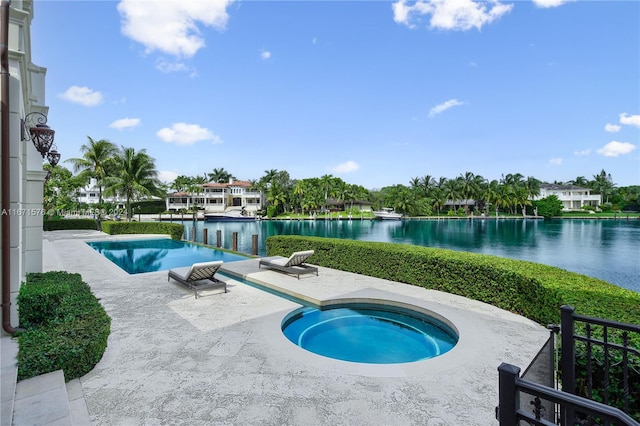 view of swimming pool featuring a patio, a water view, and an in ground hot tub