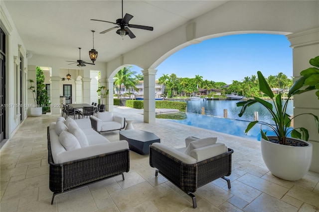 view of patio featuring an outdoor hangout area, a water view, and ceiling fan