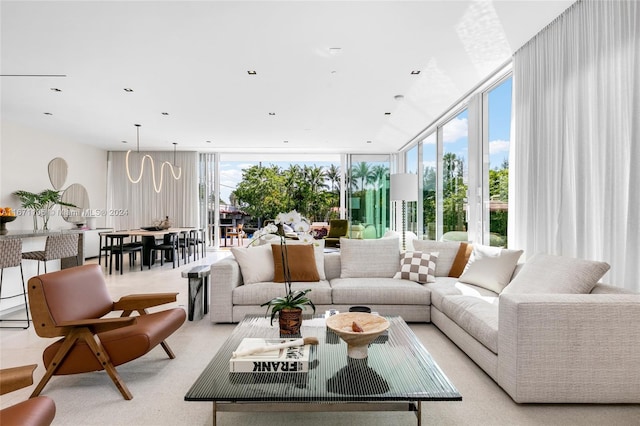 living room featuring expansive windows, plenty of natural light, and light carpet