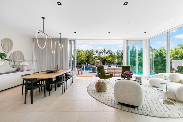 dining room with floor to ceiling windows, light tile patterned floors, and plenty of natural light