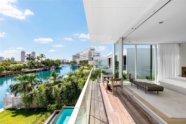 balcony featuring outdoor lounge area and a water view