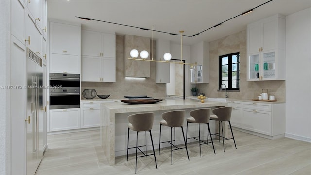 kitchen featuring a kitchen island, white cabinets, and a kitchen bar