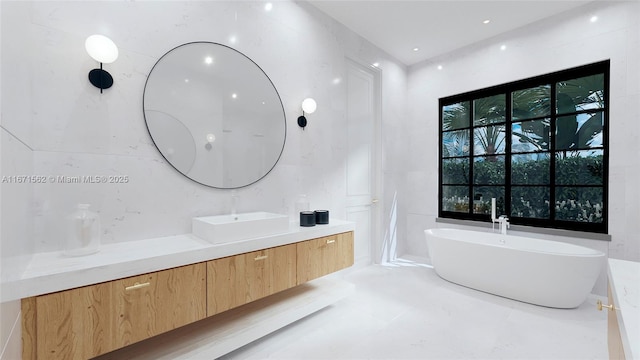 bathroom featuring a washtub and vanity