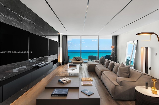 living room with a wall of windows and hardwood / wood-style floors