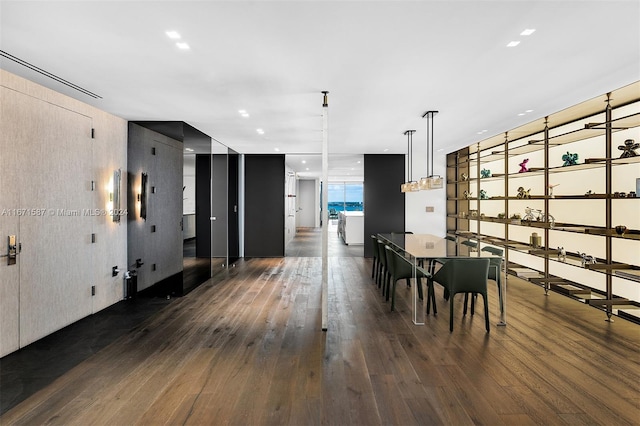 unfurnished dining area featuring dark wood-type flooring