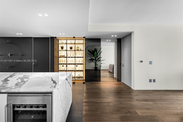 kitchen featuring wine cooler, light stone countertops, and dark hardwood / wood-style floors