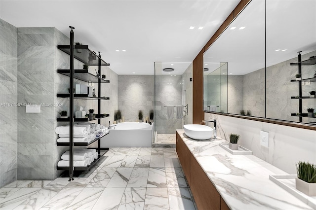 bathroom featuring vanity, shower with separate bathtub, and tile walls