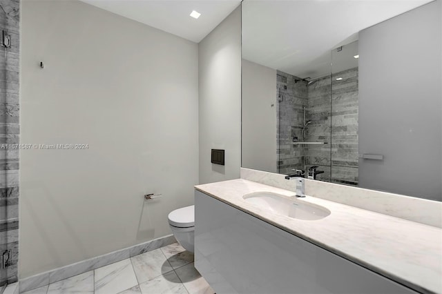 bathroom featuring a shower with door, toilet, and vanity