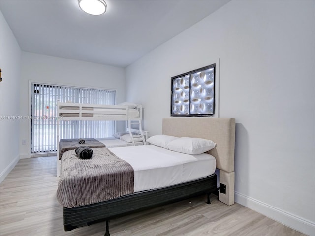 bedroom featuring baseboards and wood finished floors
