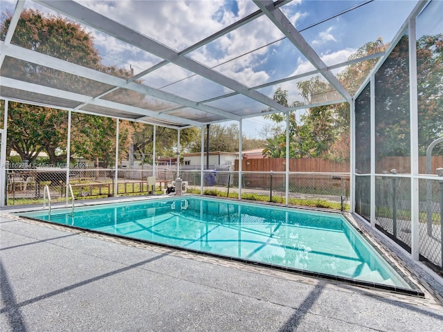 view of swimming pool featuring glass enclosure, fence, and a fenced in pool