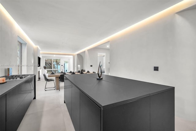 kitchen with stainless steel gas cooktop and a large island with sink