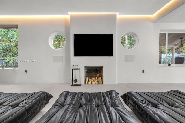 bedroom featuring multiple windows and a fireplace