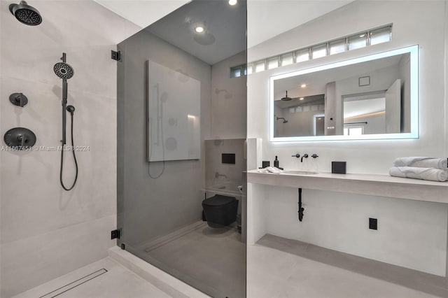 bathroom featuring a tile shower, lofted ceiling, and sink